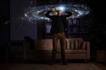 Obraz na płótnie Canvas Man uses virtual reality glasses to see the galaxy space. Elements of this image furnished by NASA.