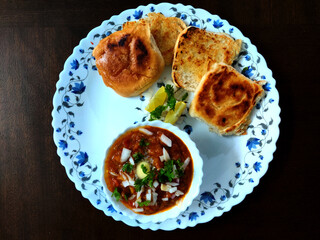 Indian Mumbai food Pav bhaji from vegetables with bread close-up in a bowl on the table. horizontal top view from above