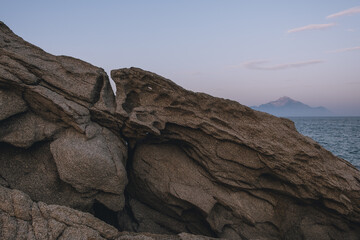 Close-up stone and blue sea behind 