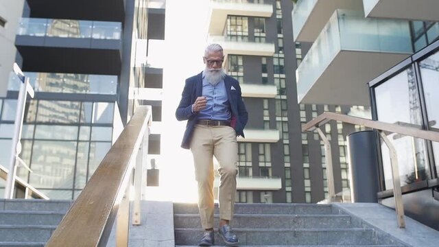 Hipster senior lifestyle moments. Handsome man with long beard spending time in downtown