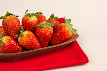 Red fresh strawberry in a bowl on white background.