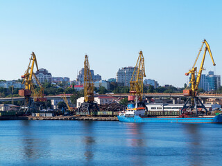 Naklejka premium Odessa, Ukraine - August 15, 2016: Container cranes in cargo port terminal, cargo cranes without job in an empty harbor port. 