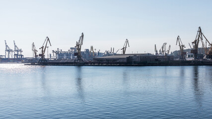 Fototapeta na wymiar Odessa, Ukraine - August 15, 2016: Container cranes in cargo port terminal, cargo cranes without job in an empty harbor port. 