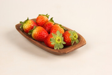 Red fresh strawberry in a bowl on white background.