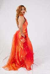 Lovely Hispanic woman in a flowing orange dress