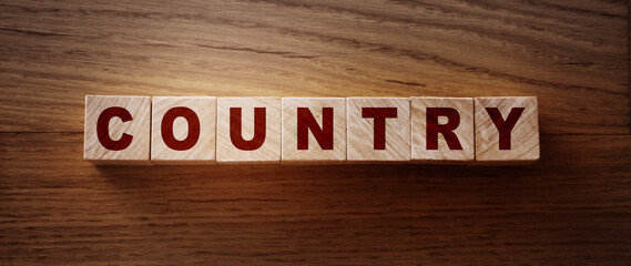 Country word on wooden cubes, geography economy concept
