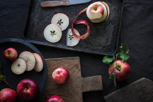 Fresh Red Apple Slices On Cutting Board And Sheet Pan