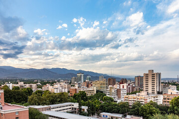city of mendoza in sunset with dark clouds and living area