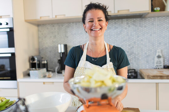 Portrait Happy Woman Cooking In Kitchen