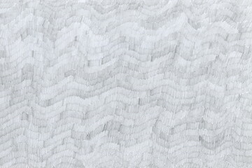 Grunge texture of undulating strokes drawn with a simple pencil that filled the entire sheet. Monochrome abstract background drawn by hand. Small strokes made in waves.