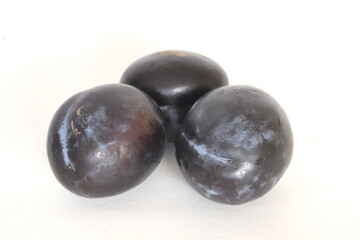 plums on a white background