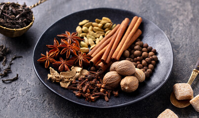 Spices for Indian masala tea. Grey background. Close up.