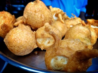 Close shot of indian street food made of the paste of gram and filled with bananas, chillies and...