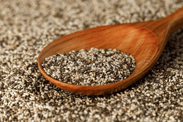 Wooden spoon with chia seeds close up