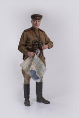 Male actor in the uniform of a Soviet Army officer during World War II with a map of the area in...