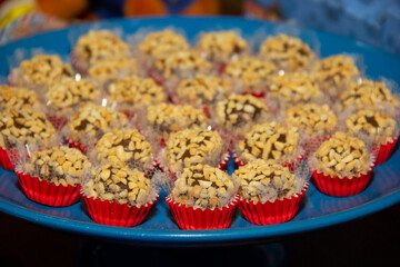 Peanut brigadeiro on the decorated birthday table, traditional Brazilian party candy