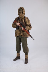 Male actor in protective camouflage of a sniper, military uniform of a soldier of the German army...