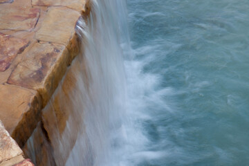 Waterfall over a rock wall