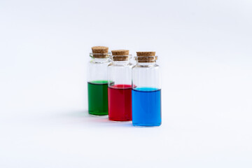 Three closed vials with colored contents on a white background.