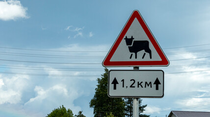 road warning sign ahead of a possible appearance of animals on the road