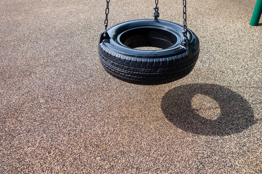 Black Chain Tire Swing At A Children's  Play Ground No People