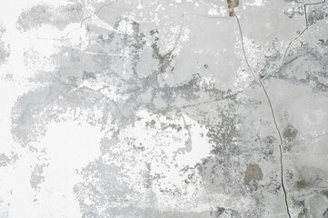 Concrete background. White flaky plaster over unpainted concrete wall
