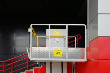 Lift for the disabled. Near the stairs of the house. View from the side. Helping infirm people.