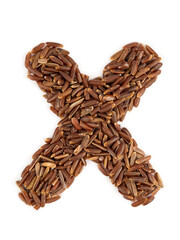 Letter X of the English alphabet made from brown rice on an isolated background.