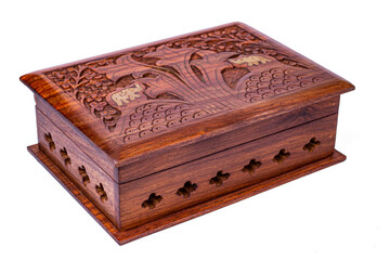 Wooden closed carved box handmade. Patterns of Indian culture in the form of elephants and wood. Isolated on a white background/