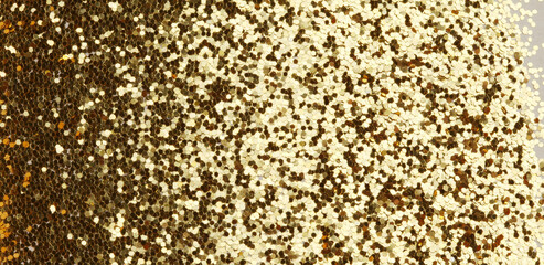Gold (bronze) glitter shine dots confetti. Abstract light blur blink sparkle defocus backgound.