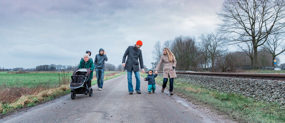 Multi-generational family walking on road