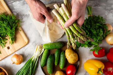 Fresh vegetables in men’s hands asparagus top view