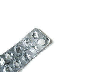 Last one white round pill in a blister pack on white background