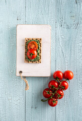 Fototapeta na wymiar Tomato and chlorella sandwich on cutting board