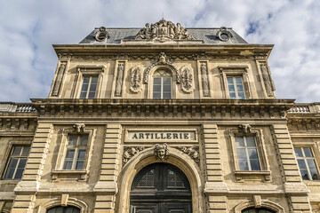 Fototapeta na wymiar Architectural fragments of old building of Military School (Ecole Militaire, founded by Louis XV in 1750). Champ de Mars, Paris, France.