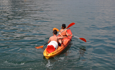 Kotor,Montenegro-08.01.2019 year. Close-up of a kayak with two ecotourists in the Bay of Kotor near the coast of the old city.