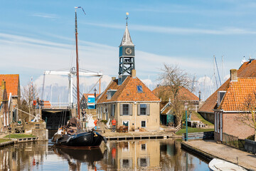 Traditional flatboat in front of the old sluice in Hindeloopen, Netherlands