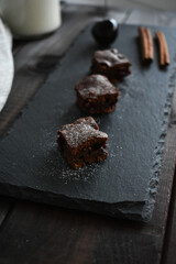 chocolate brownie with cherry on a stone plate