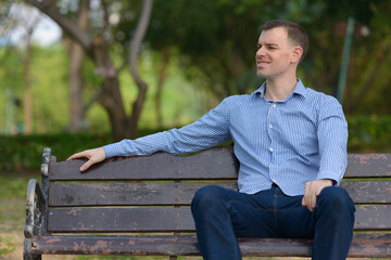 Fototapeta premium Portrait of happy businessman relaxing at the park