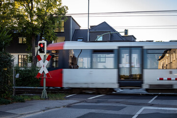 Cologne tram at a street crossing, traffic light is on red