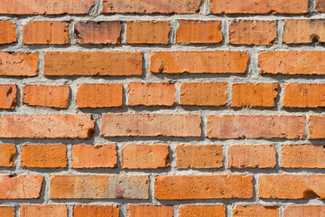 Red brick wall close up. Brick wall in sunlight for use as background