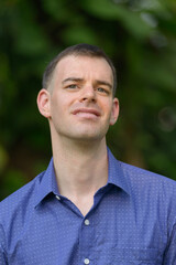 Fototapeta premium Portrait of happy businessman relaxing at the park