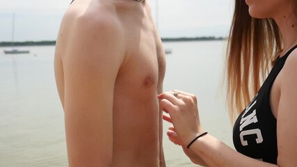 Young Man and Woman gently touch each other Body on a Beach