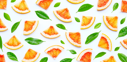 High vitamin C. Juicy grapefruit slices with green leaves on white