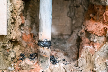 Fototapeta premium weld seam on steel pipe of water supply system in home wall close up