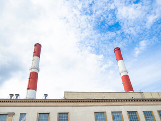 Fototapeta na wymiar chimneys of city termal power station over industrial building on Sunday summer day in Moscow city