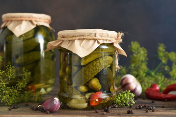 Pickled cucumbers with dill and garlic in a glass jar.