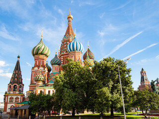 view of Saint Basil (Vasily The Blessed, Pokrovsky) cathedral on Red Square under blue sky during city sightseeing tour on excursion bus in Moscow city in summer