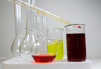 Laboratory chemical liquid elements and research diagnoses, instruments and objects in the sterile table, glassware and pipette.