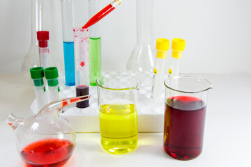 Laboratory chemical liquid elements and research diagnoses, instruments and objects in the sterile table, glassware and pipette.